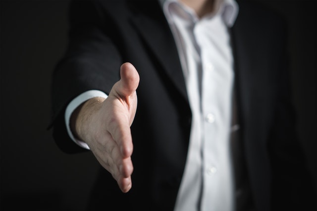 close up of human hand man in suit